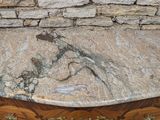 a marble top on a marble top table in front of a stone wall