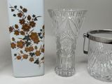 two vases and a pitcher sitting on a table