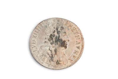 an image of a coin with a hand print on it