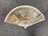 a fan with a painting on it sitting on the floor