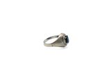 an image of a silver ring with a blue stone in it
