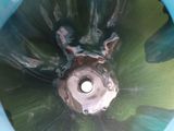 a close up view of a toilet bowl with a green lid