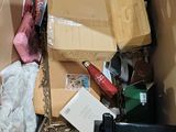 a cardboard box full of assorted items in it