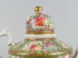 a tea pot with a lid that has a design on it