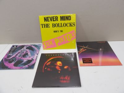a group of three cds sitting on top of a white table
