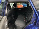 a blue car that is sitting in the back of the car