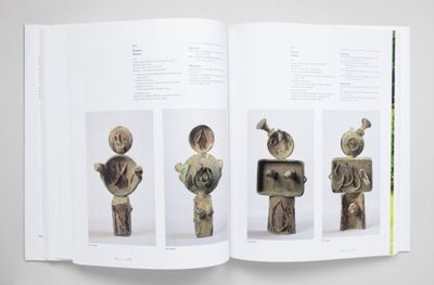 an open book with pictures of sculptures on it
