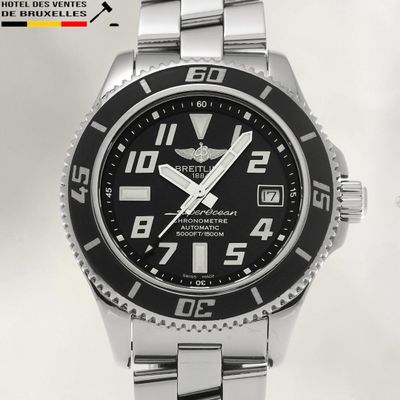 a close up of a watch on a white surface