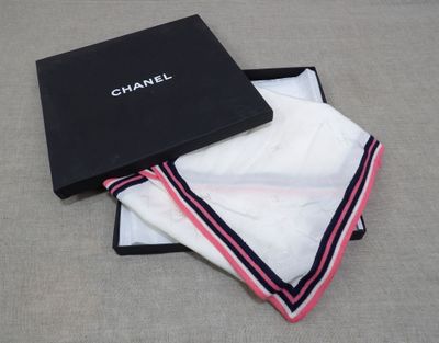 a black box with a white towel and a black box with a red and white stripe