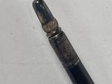 a pen that is laying on a white surface