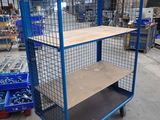 blue wire mesh shelf cart with shelves in warehouse