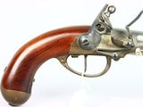 an old gun with a wooden handle on display on a white surface