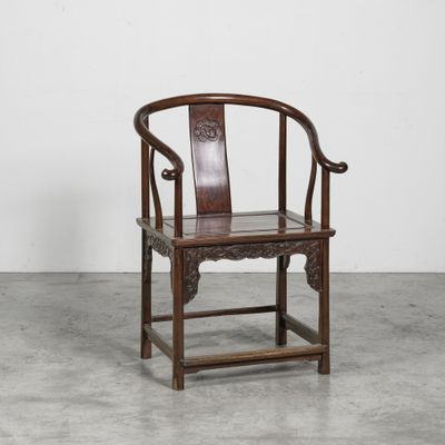 an old wooden chair sitting on top of a cement floor