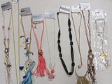 a lot of necklaces that are hanging on the wall