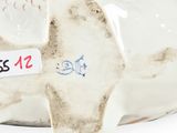 a ceramic elephant with a tag on it ' s side