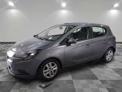the grey car is parked in the garage on a checkered floor