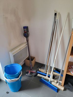a blue bucket and a blue broom in a room