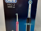 the box of the toothbrush is open on the white surface