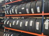 tires are stacked on shelves in a warehouse with a lot of them