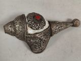 an antique silver and red broochee broochee with a red stone