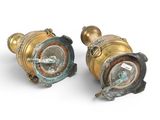 pair of antique brass oil lamps on a white background