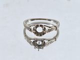 a close up of a silver ring on a white surface