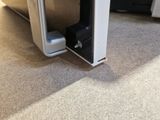 a microwave that is sitting on the floor next to a microwave oven