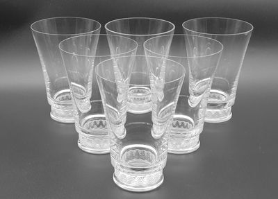six shot glasses sitting on top of a table next to each other
