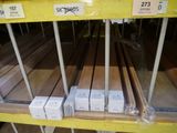 several boxes of wood are stacked on a shelf in a store