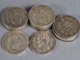six british coins sitting on top of each other on a table