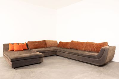 an image of a living room with a couch and ottoman