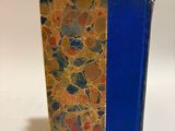a book with a blue cover sitting on a white surface
