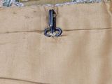 a close up of a pair of pants with a pair of scissors in the pocket