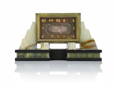 a clock that is sitting on top of a marble stand