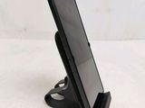 a cell phone that is on a stand on the table