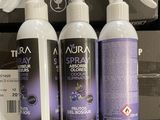 three bottles of sprays are sitting on a shelf in a store
