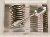 several spoons and spoon spoons in a white box with a pink and white checkered cloth