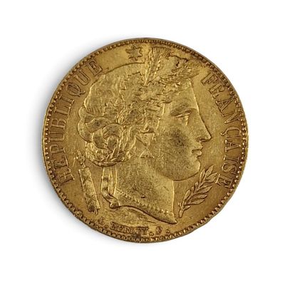 a close up of a gold coin on a white surface