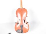 a violin that is sitting next to a piece of paper