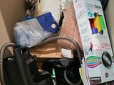 a cardboard box filled with assorted items and a camera