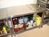 a kitchen with a stainless steel counter and a metal shelf