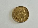 a close up of a gold coin on a white surface