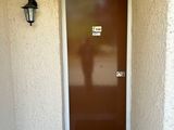 a brown door and a brown door on a white building