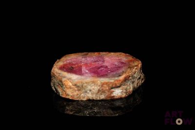 a piece of meat that is sitting on a black surface