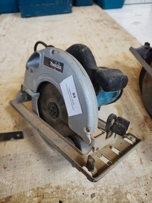 someone is using a circular saw to cut a piece of wood