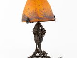 an old fashioned lamp with an orange shade on a white background