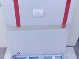 a white box with a red stripe on it sitting on the floor