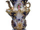 a vase that has flowers in it on a white background