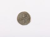a close up of a silver coin on a white surface