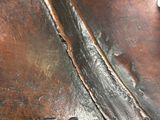 a close up of a bronze statue of a horse